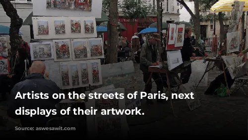 Artists on the streets of Paris, next to displays of their artwork.