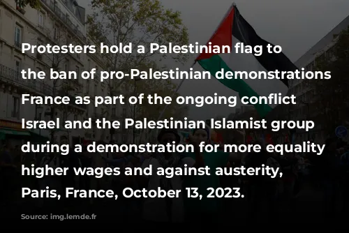 Protesters hold a Palestinian flag to protest the ban of pro-Palestinian demonstrations in France as part of the ongoing conflict between Israel and the Palestinian Islamist group Hamas, during a demonstration for more equality and higher wages and against austerity, in Paris, France, October 13, 2023.