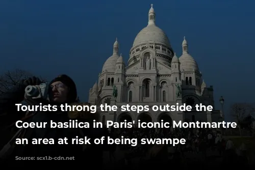 Tourists throng the steps outside the Sacre Coeur basilica in Paris' iconic Montmartre district, an area at risk of being swampe