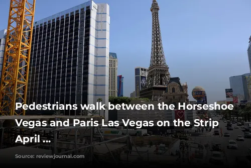 Pedestrians walk between the Horseshoe Las Vegas and Paris Las Vegas on the Strip Friday, April ...