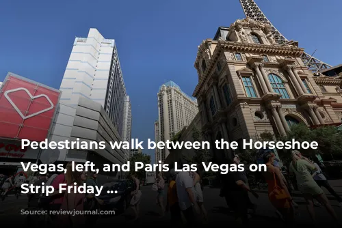 Pedestrians walk between the Horseshoe Las Vegas, left, and Paris Las Vegas on the Strip Friday ...