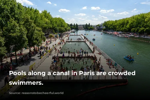 Pools along a canal in Paris are crowded with swimmers.