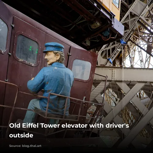 Old Eiffel Tower elevator with driver's dummy outside