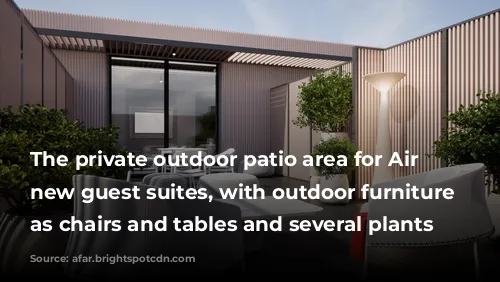 The private outdoor patio area for Air France's new guest suites, with outdoor furniture such as chairs and tables and several plants 