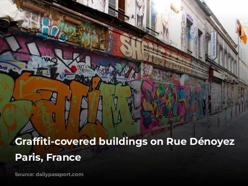 Graffiti-covered buildings on Rue Dénoyez in Paris, France