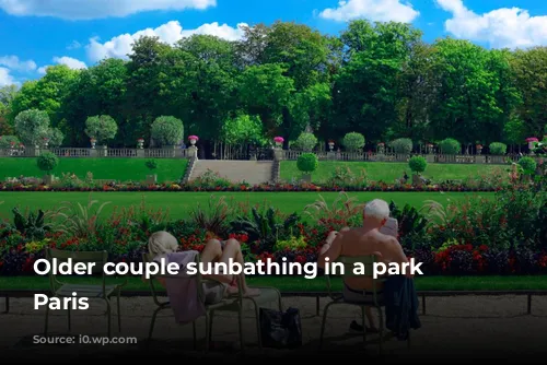 Older couple sunbathing in a park in Paris