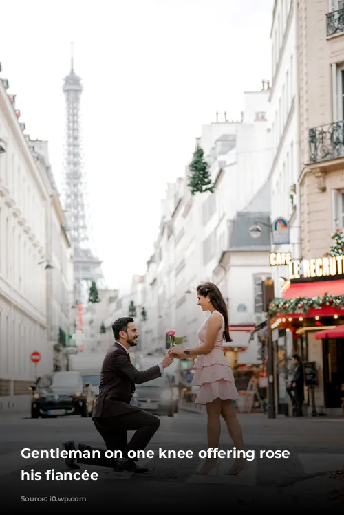 Gentleman on one knee offering rose to his fiancée