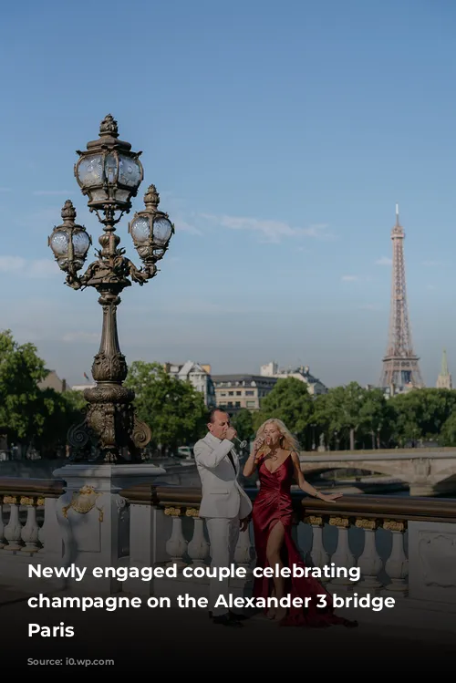 Newly engaged couple celebrating with champagne on the Alexander 3 bridge in Paris