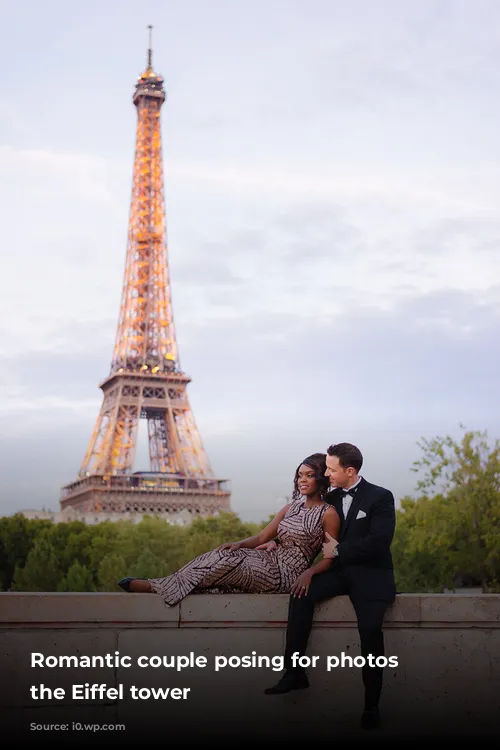 Romantic couple posing for photos by the Eiffel tower