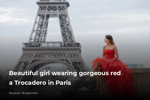 Beautiful girl wearing gorgeous red dress a Trocadero in Paris