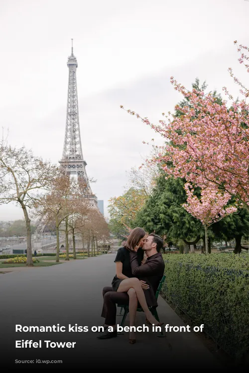 Romantic kiss on a bench in front of the Eiffel Tower