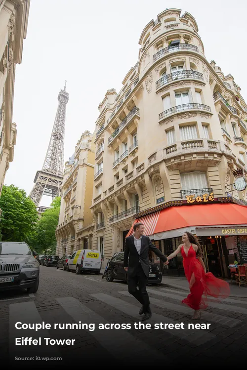 Couple running across the street near the Eiffel Tower