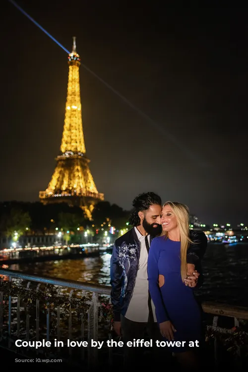 Couple in love by the eiffel tower at night