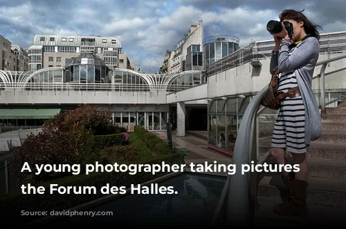 A young photographer taking pictures in the Forum des Halles.