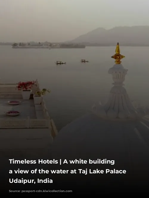 Timeless Hotels | A white building with a view of the water at Taj Lake Palace in Udaipur, India