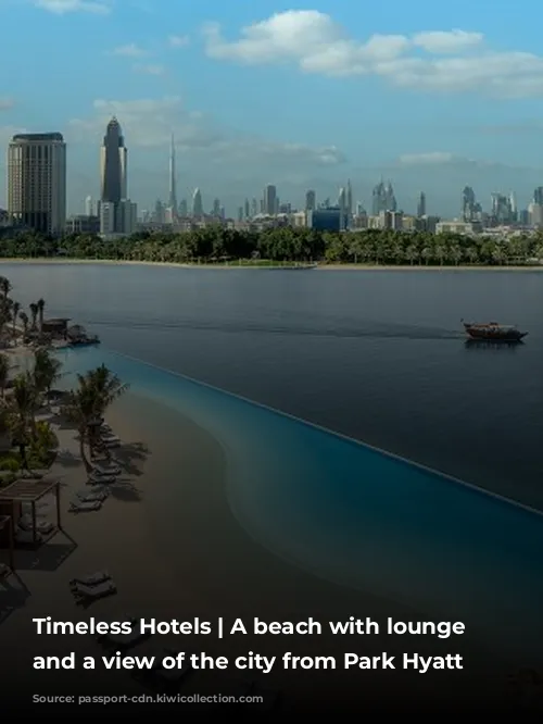 Timeless Hotels | A beach with lounge chairs and a view of the city from Park Hyatt Dubai