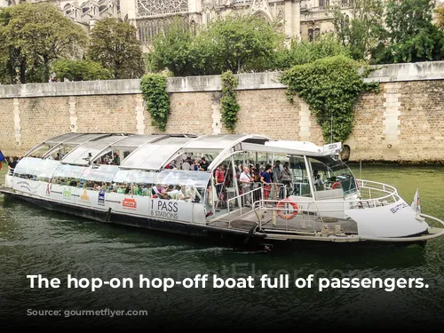 The hop-on hop-off boat full of passengers.