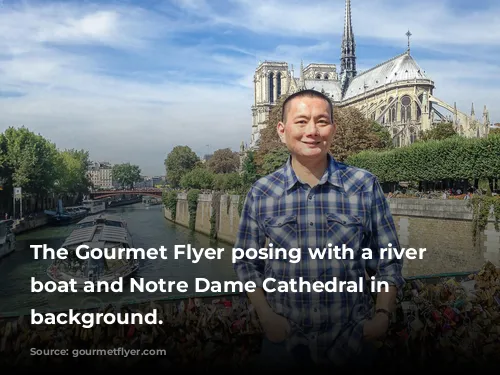 The Gourmet Flyer posing with a river cruise boat and Notre Dame Cathedral in the background.