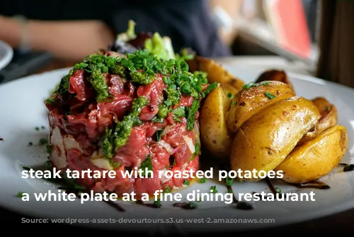 steak tartare with roasted potatoes on a white plate at a fine dining restaurant