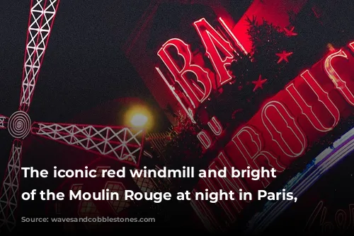 The iconic red windmill and bright lights of the Moulin Rouge at night in Paris, France.