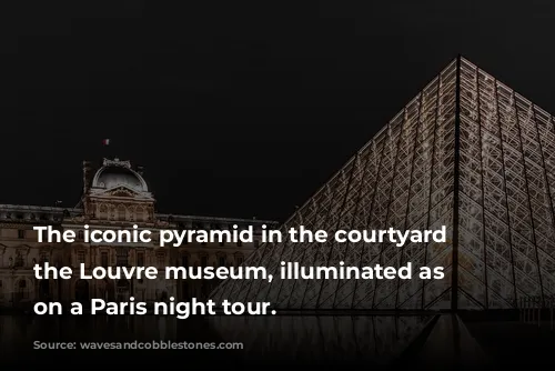 The iconic pyramid in the courtyard of the Louvre museum, illuminated as seen on a Paris night tour.