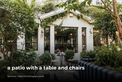 a patio with a table and chairs