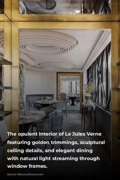 The opulent interior of Le Jules Verne restaurant, featuring golden trimmings, sculptural white ceiling details, and elegant dining arrangements, with natural light streaming through geometric window frames.