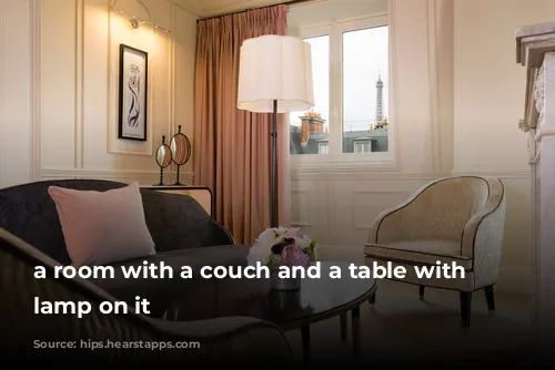 a room with a couch and a table with a lamp on it