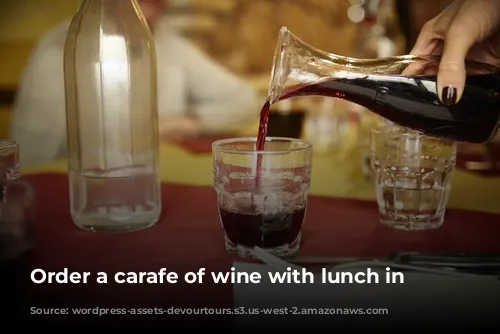 Order a carafe of wine with lunch in Paris.