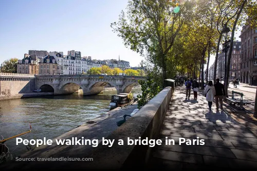 People walking by a bridge in Paris