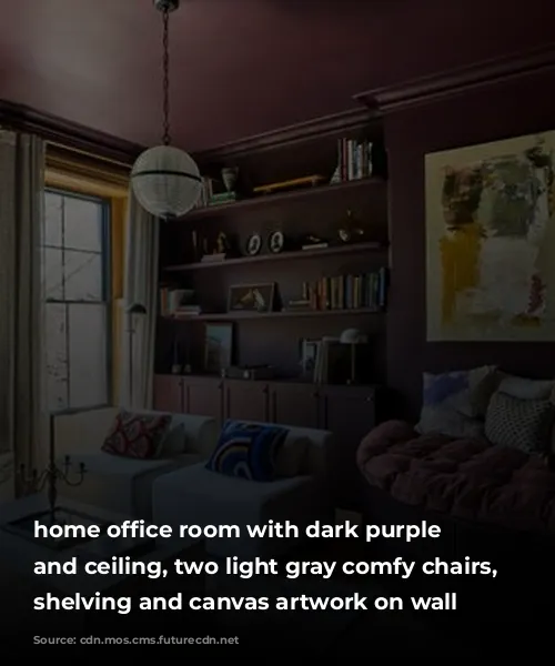 home office room with dark purple walls and ceiling, two light gray comfy chairs, built-in shelving and canvas artwork on wall