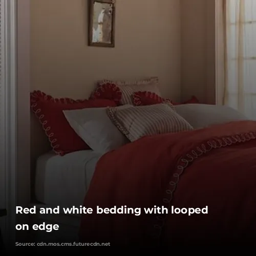 Red and white bedding with looped details on edge