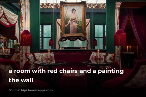 a room with red chairs and a painting on the wall