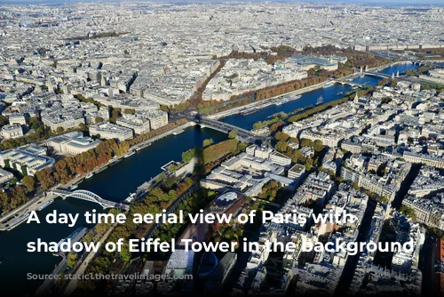 A day time aerial view of Paris with the shadow of Eiffel Tower in the background