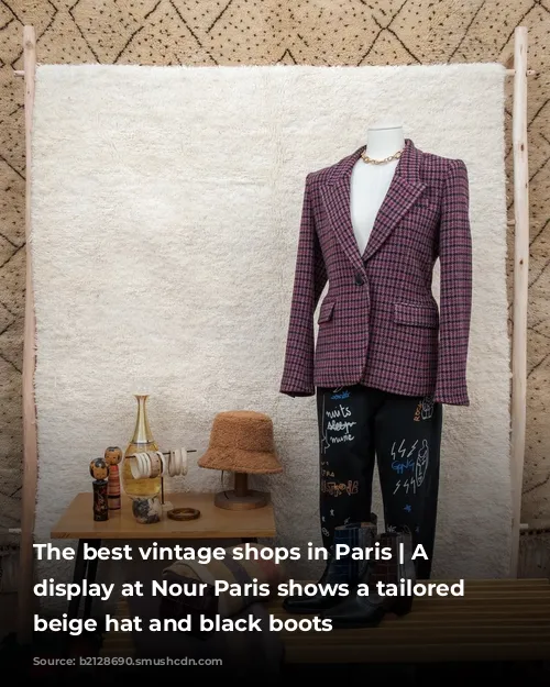 The best vintage shops in Paris | A window display at Nour Paris shows a tailored blazer, beige hat and black boots