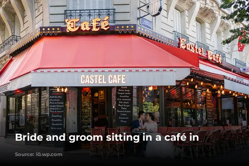 Bride and groom sitting in a café in Paris