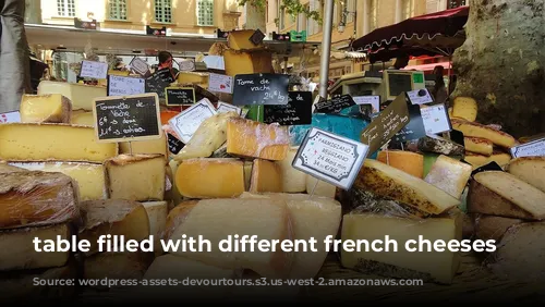 table filled with different french cheeses