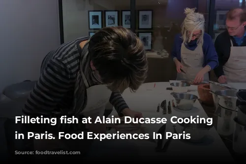 Filleting fish at Alain Ducasse Cooking School in Paris. Food Experiences In Paris