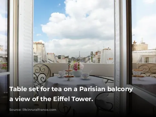 Table set for tea on a Parisian balcony with a view of the Eiffel Tower.