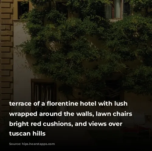 terrace of a florentine hotel with lush greenery wrapped around the walls, lawn chairs with bright red cushions, and views over the tuscan hills