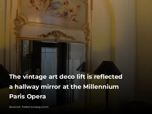 The vintage art deco lift is reflected in a hallway mirror at the Millennium Hotel Paris Opera