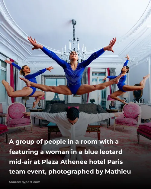 A group of people in a room with a chandelier, featuring a woman in a blue leotard jumping mid-air at Plaza Athenee hotel Paris Olympic team event, photographed by Mathieu Forget