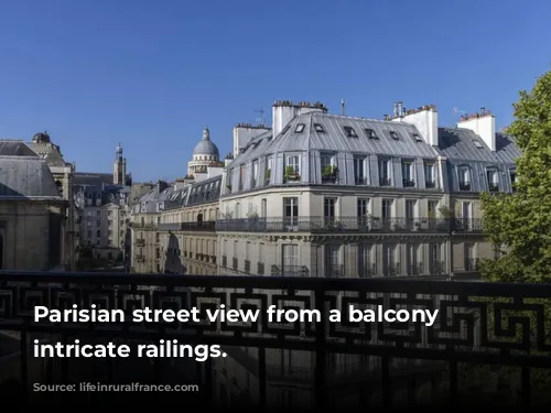 Parisian street view from a balcony with intricate railings.