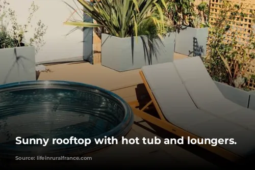 Sunny rooftop with hot tub and loungers.