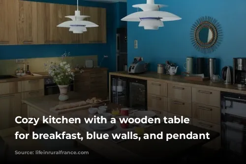 Cozy kitchen with a wooden table set for breakfast, blue walls, and pendant lights.