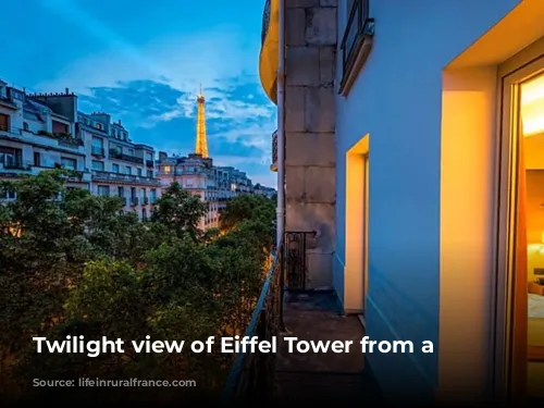 Twilight view of Eiffel Tower from a balcony.