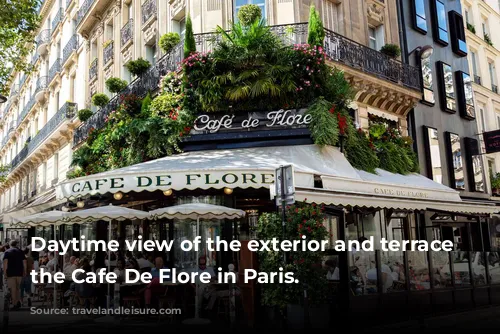 Daytime view of the exterior and terrace of the Cafe De Flore in Paris.