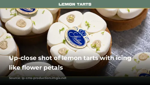 Up-close shot of lemon tarts with icing shaped like flower petals