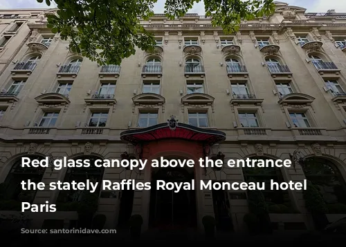 Red glass canopy above the entrance of the stately Raffles Royal Monceau hotel in Paris