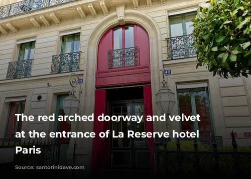 The red arched doorway and velvet curtain at the entrance of La Reserve hotel in Paris